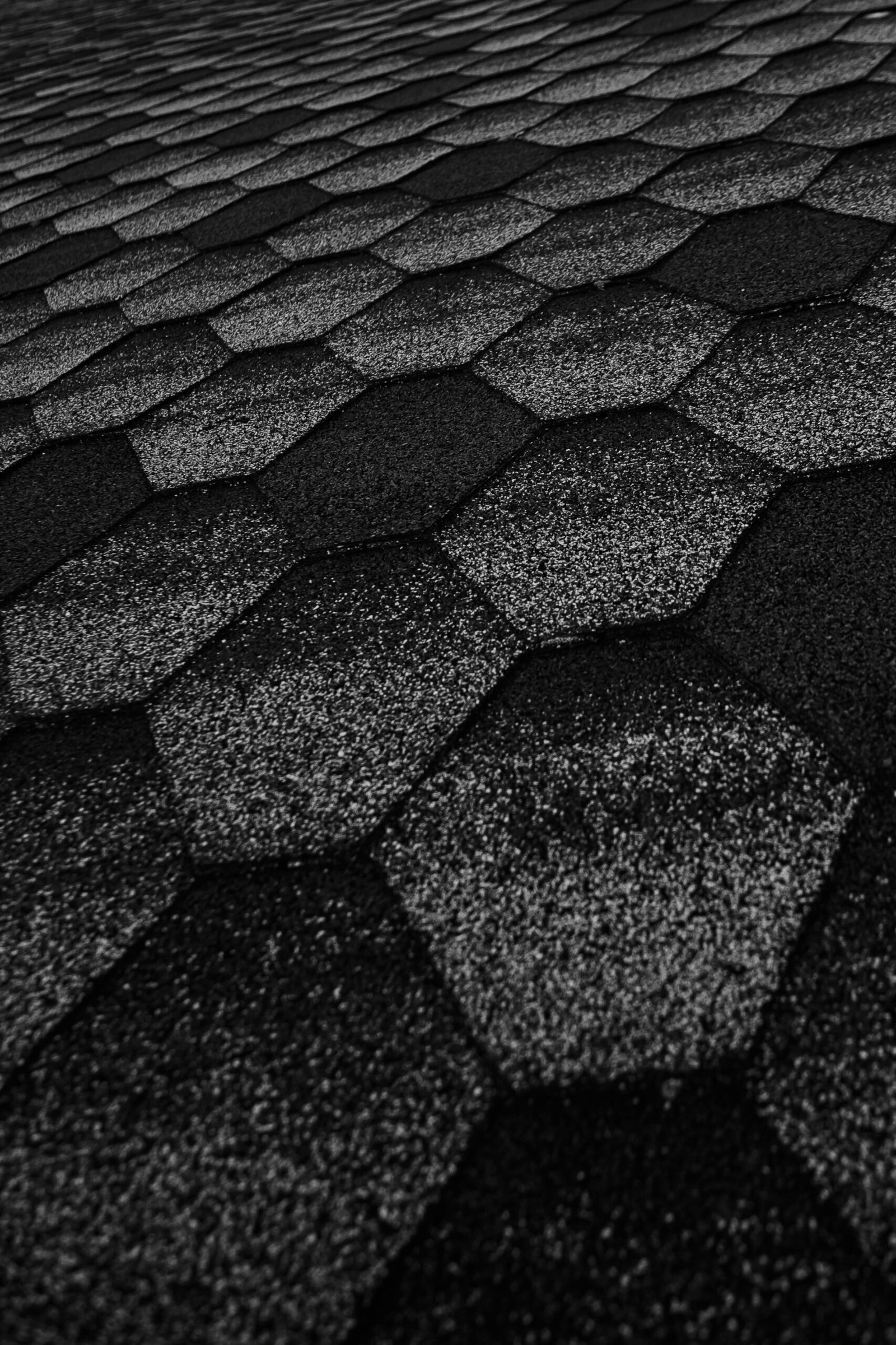 From above dark surface of path made of rough black hexagons on street